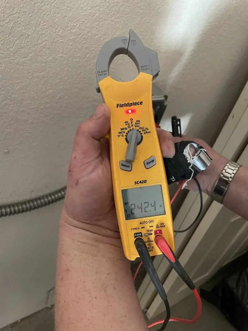 Voltage testing with clamp meter during Ceiling Fan Installation in Selmer